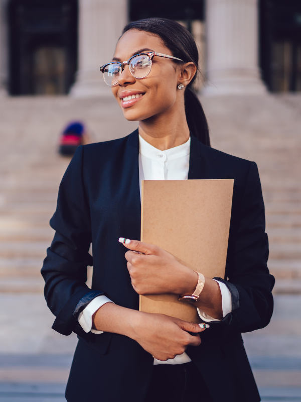 female lawyer stood with files outside courtroom